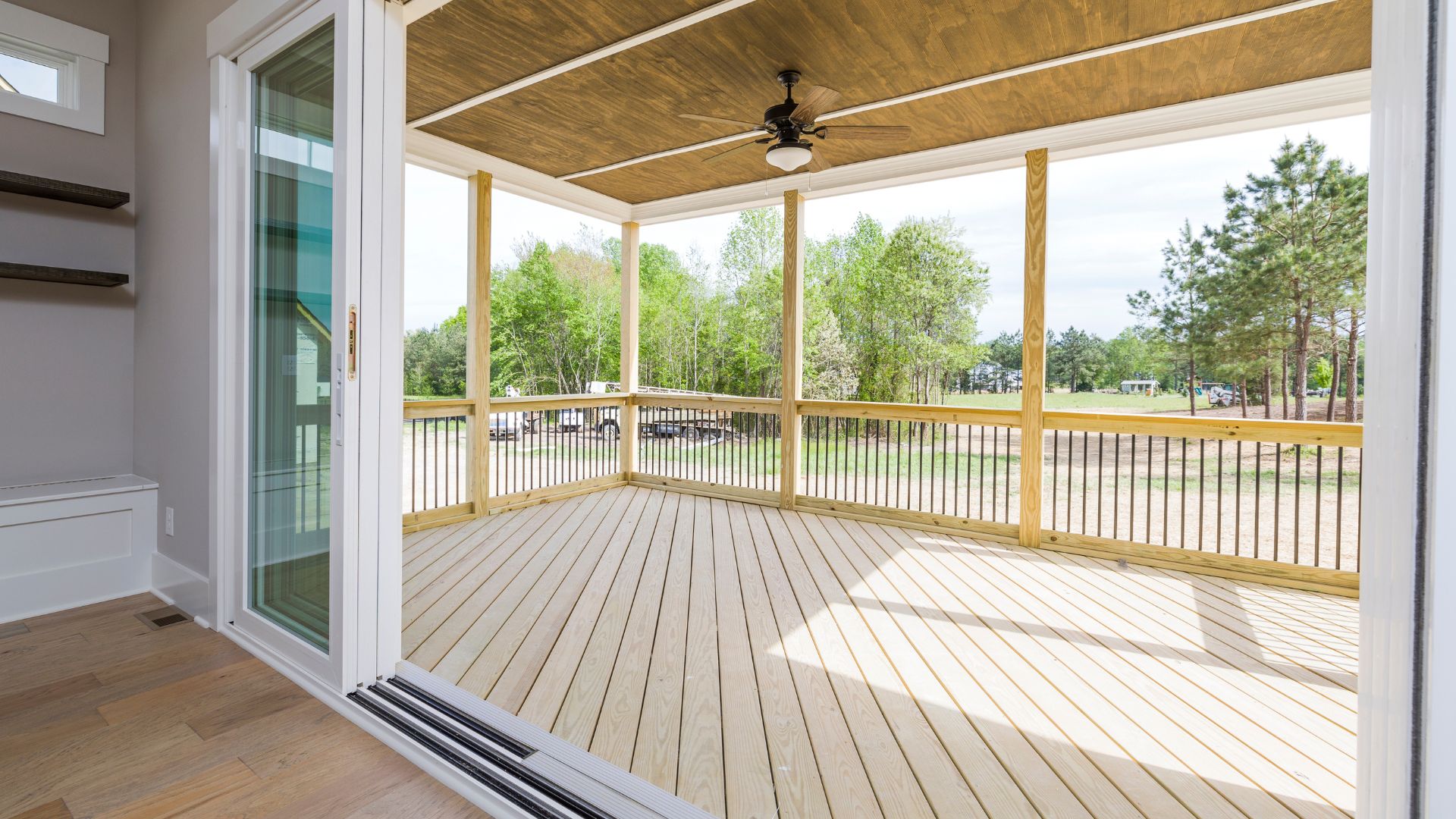 A porch with a ceiling fan and a sliding glass door