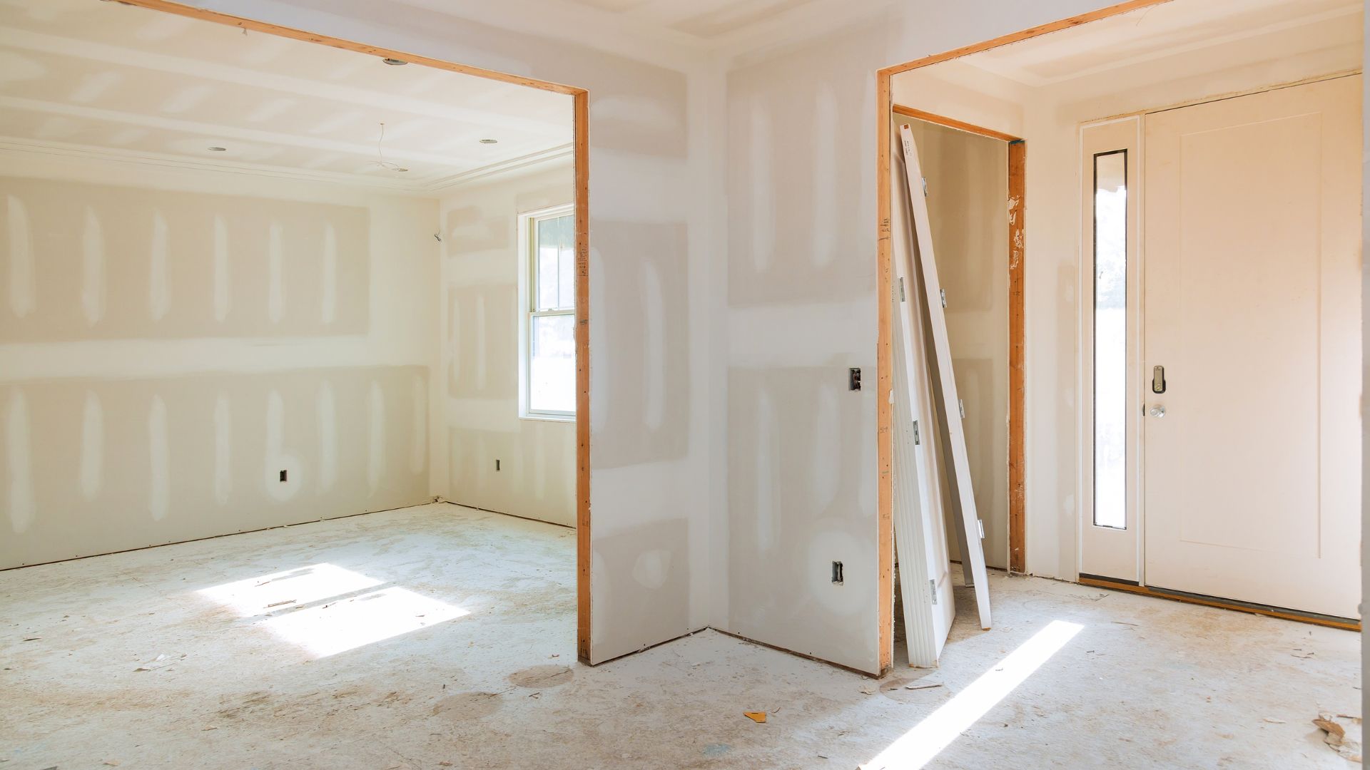 An empty room with a door and a window