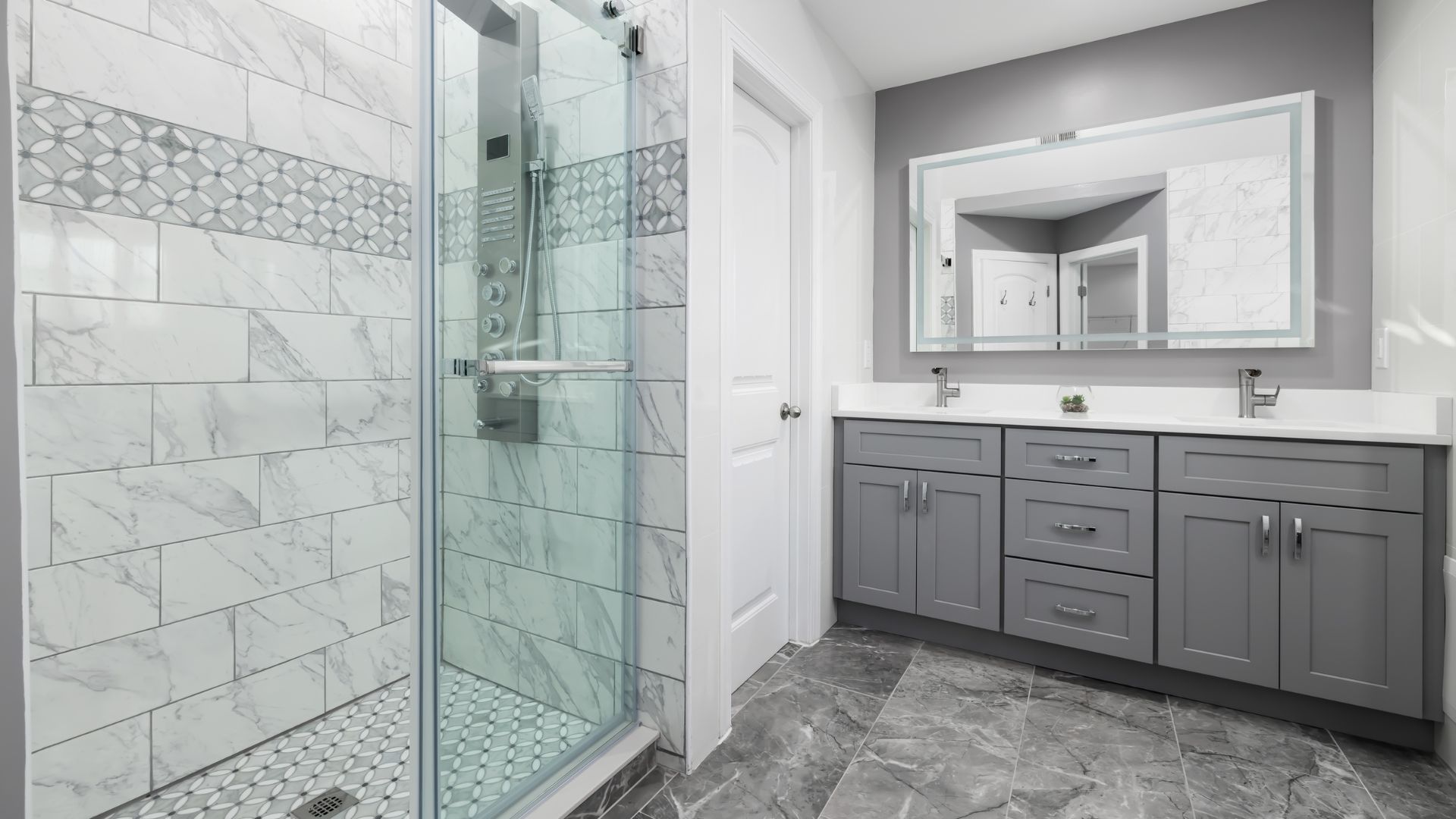 A bathroom with a walk in shower next to a sink