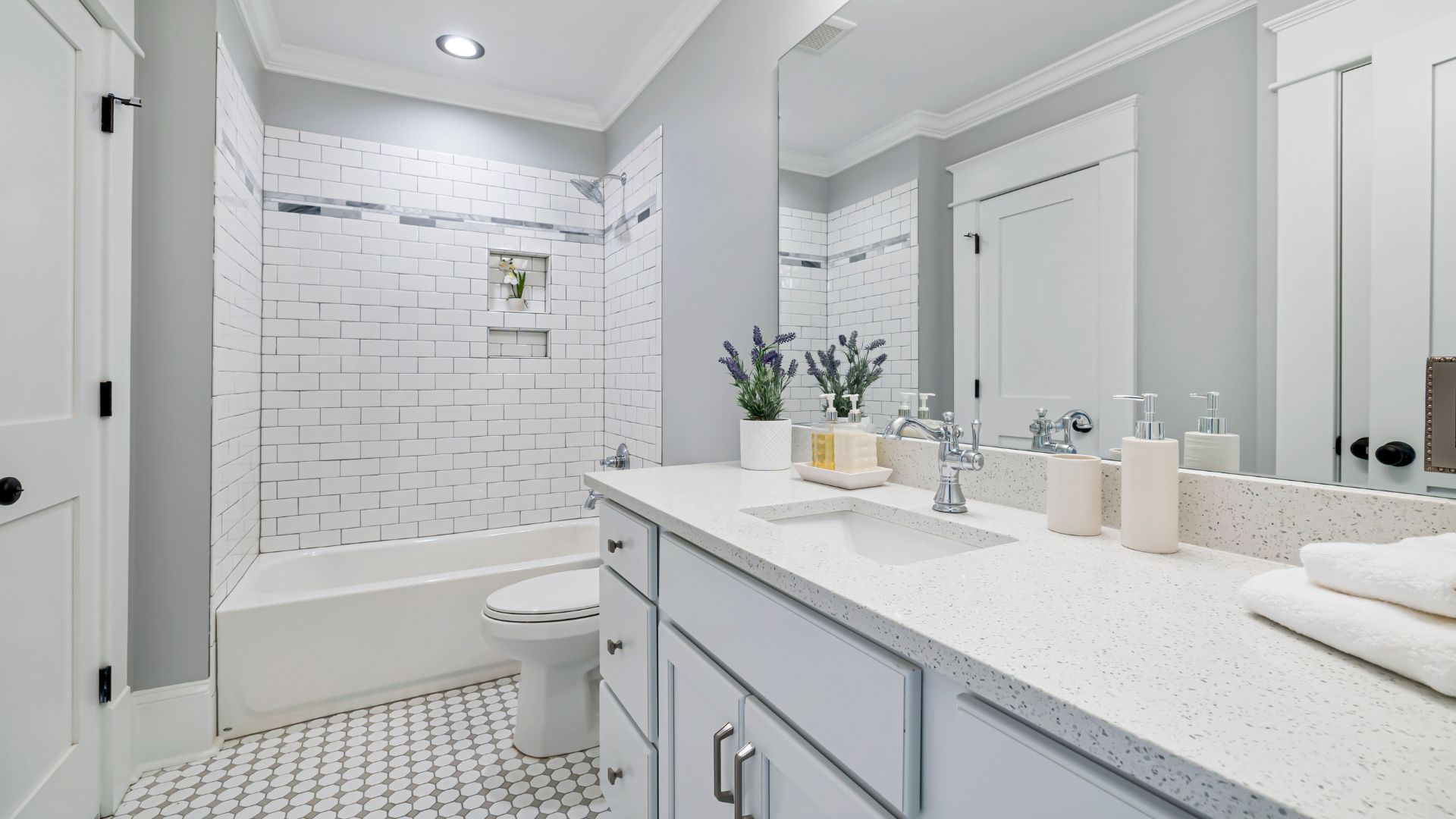 A bathroom with a sink, toilet, and bathtub